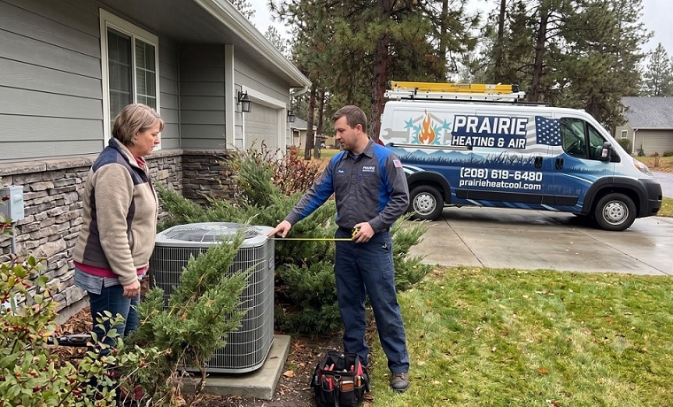 Hvac Checking Bushes With Homeowner