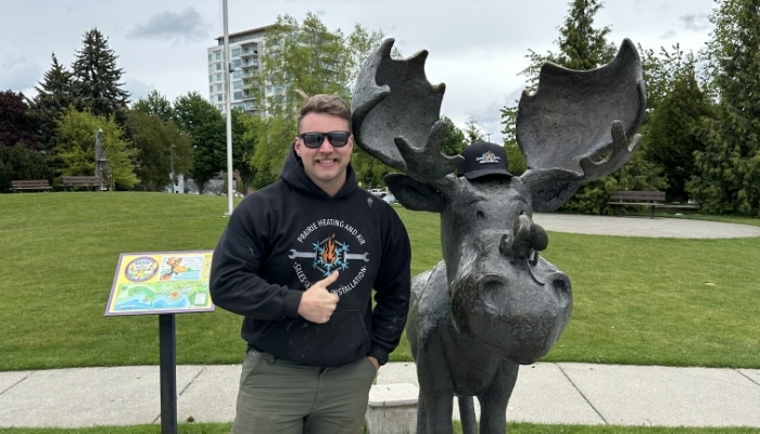 Owner Giving Thumbs Up Next To Moose Owner Giving Thumbs Up Next To Moose